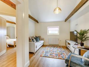 a living room with a couch and a table at Woodpecker Barn - Uk38613 in Wisbech
