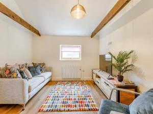 a living room with a couch and a table at Woodpecker Barn - Uk38613 in Wisbech