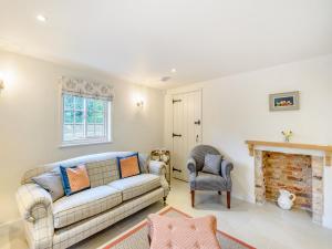 a living room with a couch and a chair at Halton Lodge in Halton Holegate