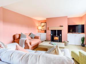 a living room with a couch and a fireplace at Limber Wold House in Great Limber