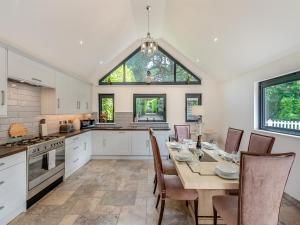 a kitchen with a table with chairs and a dining room at Foxton Lodge - Uk47296 in Harrietsham