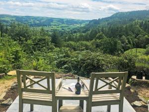 a table with a cat sitting on top at Clawdd Gwyn in Llanrwst