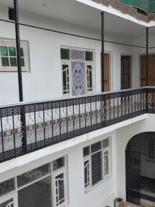 a balcony of a house with a gate and windows at Payer Resort in Pharkian