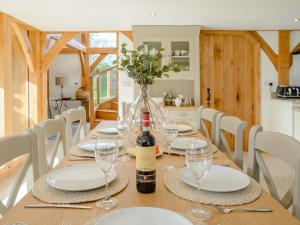 a dining table with glasses and a bottle of wine at Hare's Furrow - Uk12607 in Burton Overy +24 photos