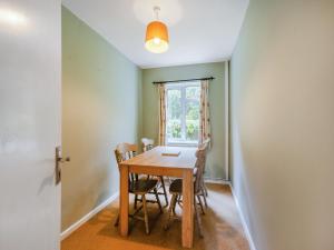 a dining room with a wooden table and chairs at Spruce Cottage - Uk46875 in Hartland