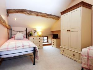a bedroom with a bed and a dresser at Birch Cottage - Uk4185 in Hazlehead Bridge
