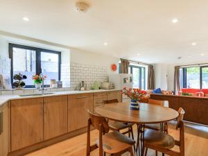 a kitchen and dining room with a table and chairs at Coach House - Uk32202 in Burton Bradstock +19 photos