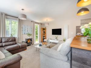 a living room with a couch and a fireplace at Dower House Lodge in Ludlow