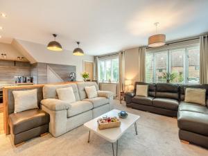 a living room with a couch and a table at Dower House Lodge in Ludlow
