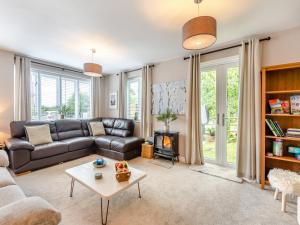 a living room with a couch and a fireplace at Dower House Lodge in Ludlow