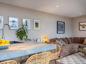 a kitchen and living room with a couch and a table at The Granary - Uk48622 in Buchlyvie
