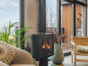 a fireplace in a living room with a couch at The Granary - Uk48622 in Buchlyvie