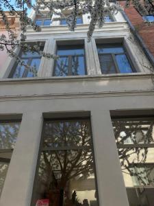 a tall white building with glass windows at Vintage Lovers Antwerp in Antwerp +31 photos