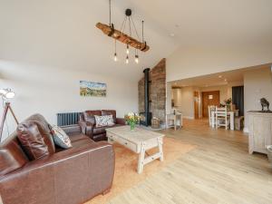 a living room with a couch and a table at Tyr Ywen Cottage in Abergavenny