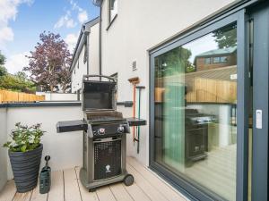 a grill on a patio next to a window at Puckoo's Nest in Newquay +35 photos