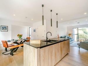 a kitchen with a sink and a dining room at Puckoo's Nest in Newquay