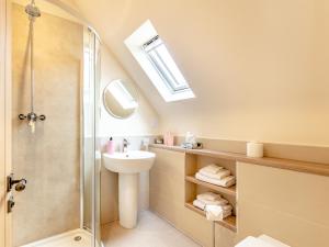 a bathroom with a sink and a shower at Rose Cottage - Uk39245 in Inverness