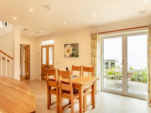 a kitchen and dining room with a table and chairs at Rose Cottage - Uk39245 in Inverness +18 photos