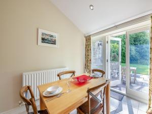 a dining room with a wooden table and chairs at Shellrigg - Uk49891 in Preston