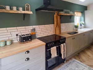 a kitchen with a black stove top oven next to a counter at Normandy in Wyberton
