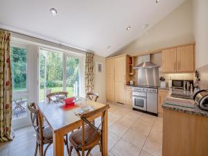 a kitchen with a table and chairs and a kitchen with a window at Shellrigg - Uk49891 in Preston