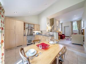 a kitchen and dining room with a wooden table and chairs at Shellrigg - Uk49891 in Preston
