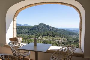 a table and chairs on a balcony with a view at Posada del Marqués I A Slow Design Hotel in Esporles +37 photos