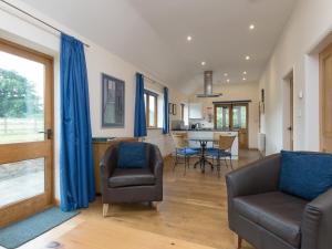 a living room with a couch and chairs and a table at Parkers Lodge in Mathon