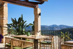 a table and chairs on a balcony with a view at Posada del Marqués I A Slow Design Hotel in Esporles