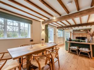 a dining room with a wooden table and chairs at Mousehall Oast in Wadhurst