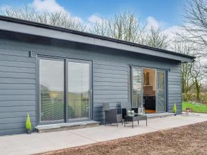 a house with large sliding glass doors on it at Lime Tree Lodge in Castle Douglas