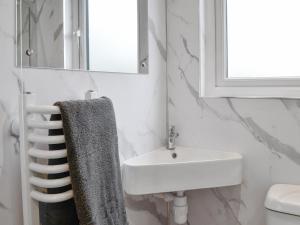 a bathroom with a sink and a towel at Lime Tree Lodge in Castle Douglas