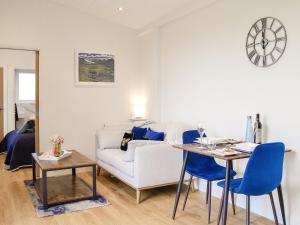 a living room with a couch and a table at Lime Tree Lodge in Castle Douglas +10 photos