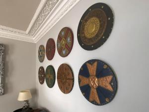 a bunch of plates hanging on a wall at Clan Young Suite in Berwick-Upon-Tweed