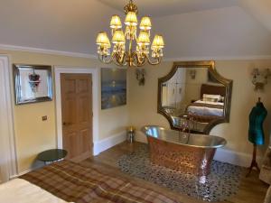 a bathroom with a large mirror and a tub at Clan Young Suite in Berwick-Upon-Tweed +6 photos