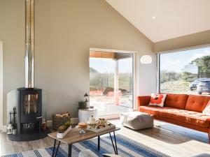 a living room with a couch and a fireplace at Drums Beach House in Foveran