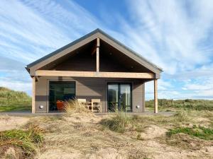 a small house in the middle of a field at Drums Beach House in Foveran