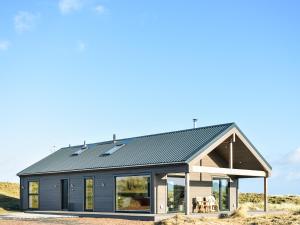 a house with solar panels on its roof at Drums Beach House in Foveran