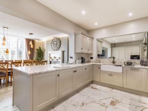 a kitchen with white cabinets and a dining room at No3 On The Severn in Bridgnorth +39 photos