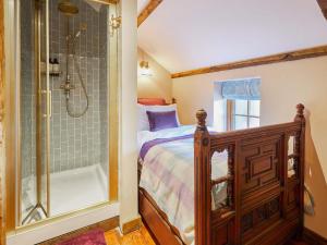 a bedroom with a bed and a shower at Rustic Retreat in Llangadog