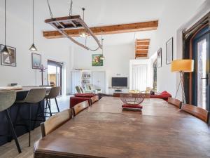 a dining room and living room with a large wooden table at The Cart Arms in Gloucester +18 photos