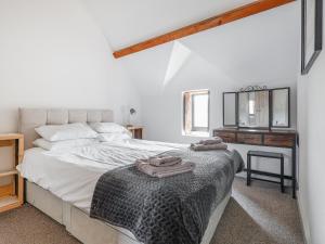 a bedroom with a bed with a dresser and a mirror at The Cart Arms in Gloucester