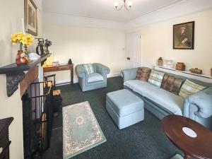 a living room with a couch and a table at Hill View in Minehead