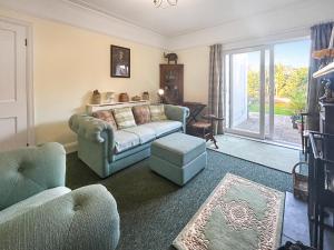 a living room with a couch and a window at Hill View in Minehead