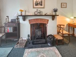 a living room with a fireplace and a table at Hill View in Minehead