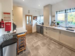 a large kitchen with a sink and a counter at Hill View in Minehead +26 photos