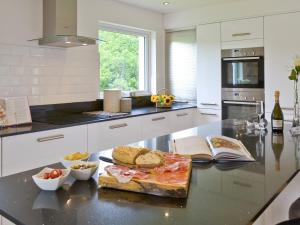 a kitchen with a counter with a plate of food on it at Florina in Cheriton Bishop
