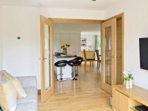 a living room with two stools and a kitchen at Florina in Cheriton Bishop +20 photos
