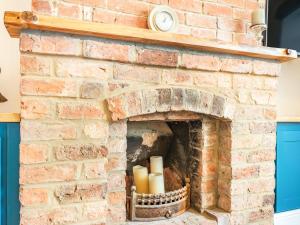 a brick fireplace with candles in it at Stonegarth in Snitterby