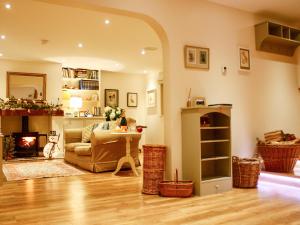 a living room with a couch and a table at The Owl House in Bishops Waltham